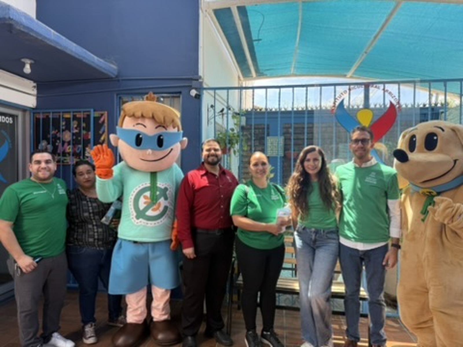 Equipo y mascotas de Familia Sin Gluten frente al instituto